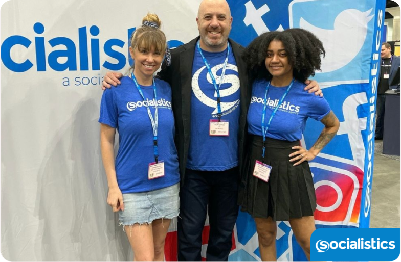 Socialistics team of 3 with their id cards in an event booth.